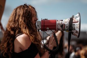 Woman speaking loudly through a megaphone