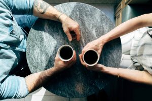 Two people talking over coffee