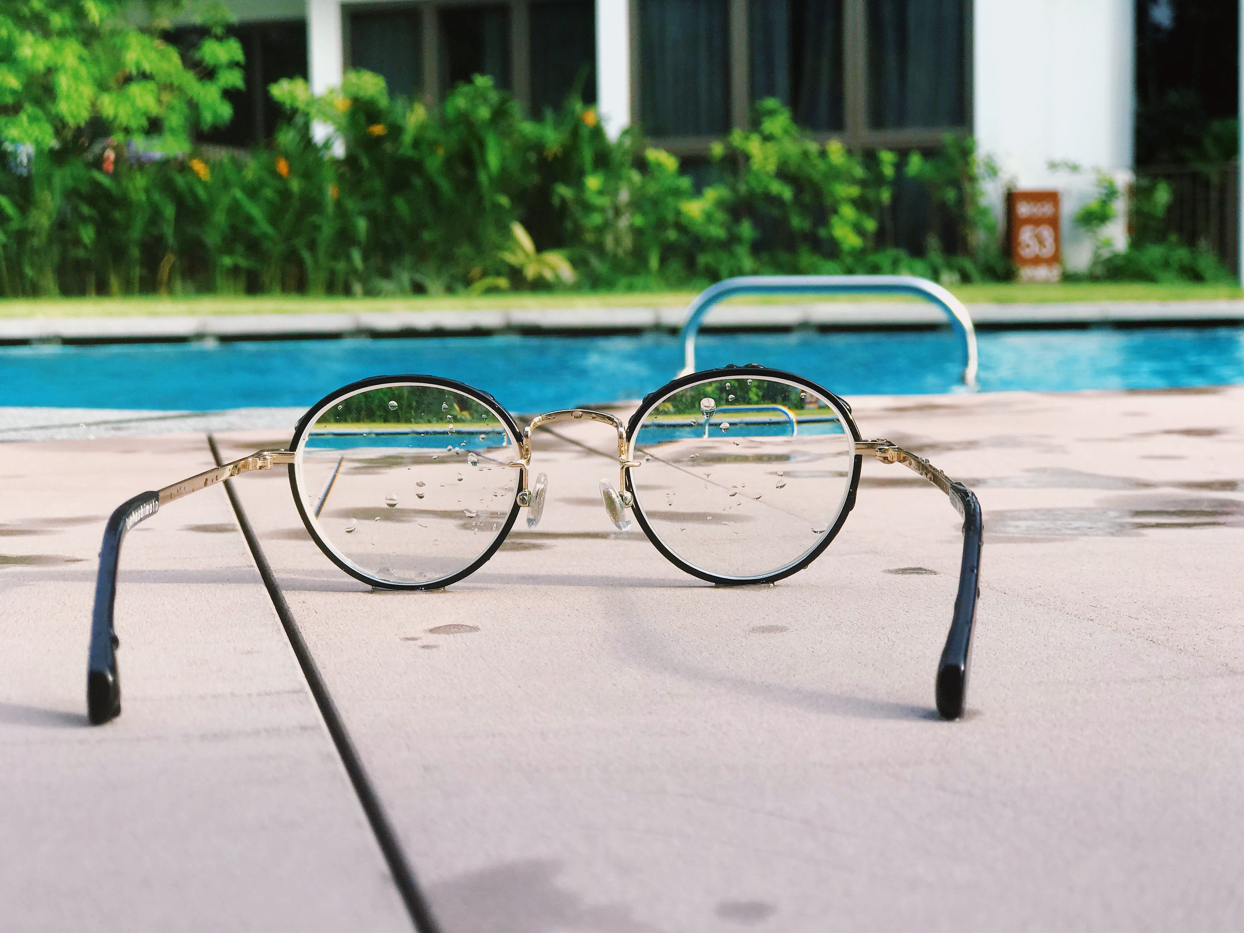 Reading glasses next to a pool